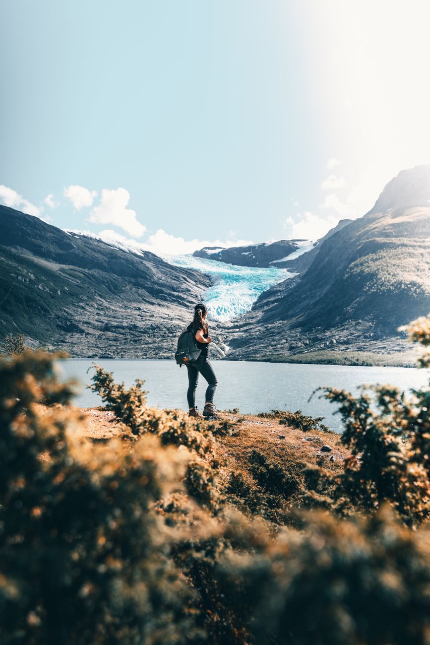 Traveler looking over Scandinavian fjord landscape