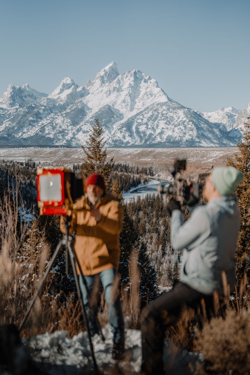 Photographer with vintage camera in mountain forest
